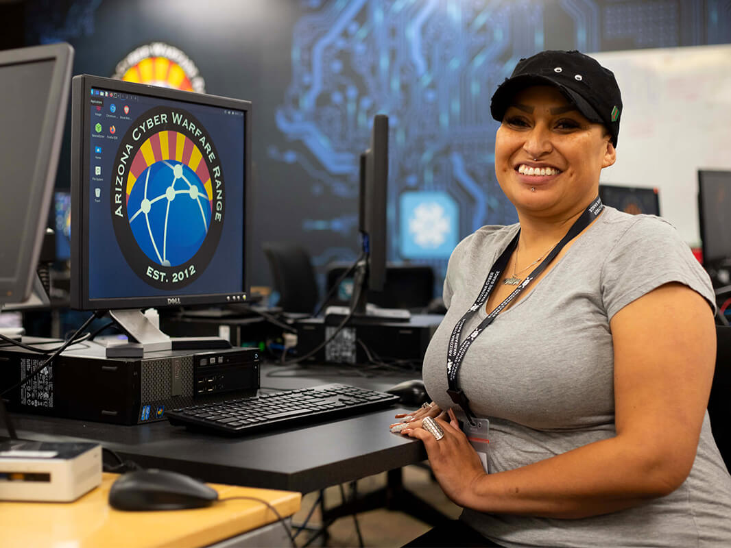 A student smiles in the Cyber Warfare Range