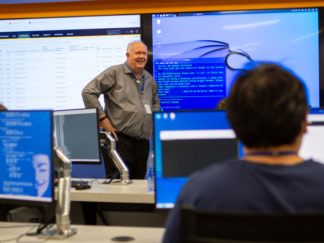 A teacher lectures in the Cybersecurity Operations Center