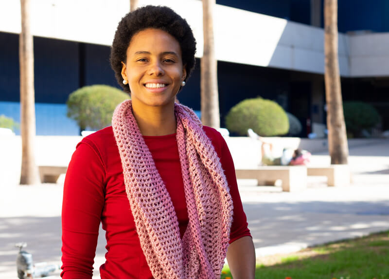 Lorena stands smiling in a West Campus Breezeway