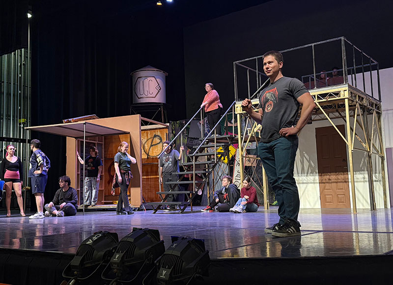 The cast of Urinetown rehearsing on the developing set pieces by Zora Street.