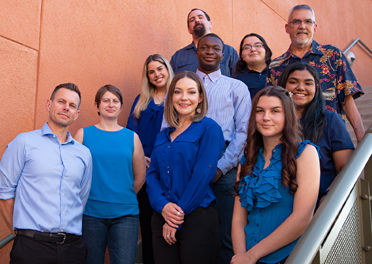 The Grow Academy Group smiling on a staircase at Northwest Campus