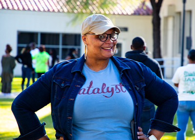 Treya Allen stand smiling at a Black History Month Event at Downtown Campus