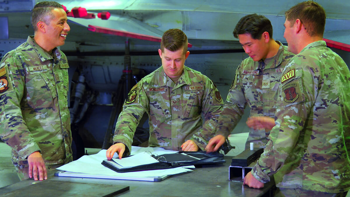 Matt Mendez works with team mates at a national air guard base.