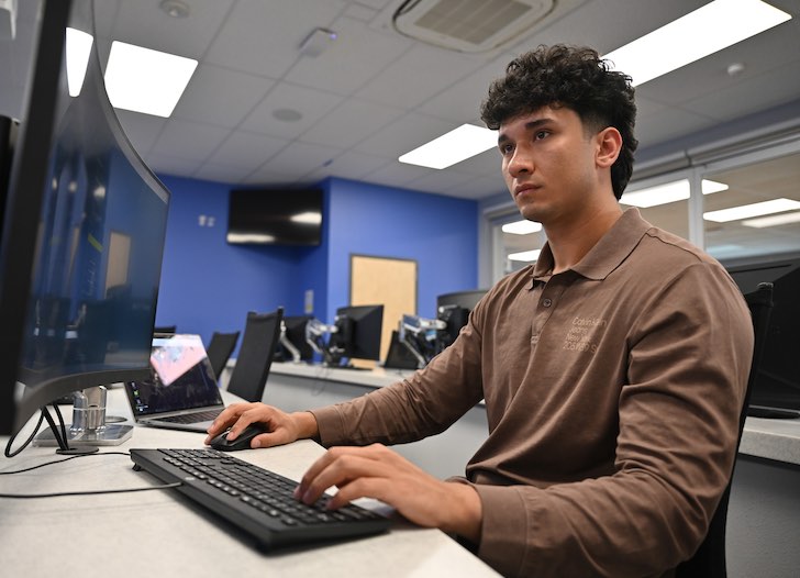 Zamir at a computer terminal at the cybersecurity  lab.