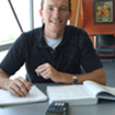 male student with notebook and calculator