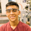 man wearing safety goggles in manufacturing setting