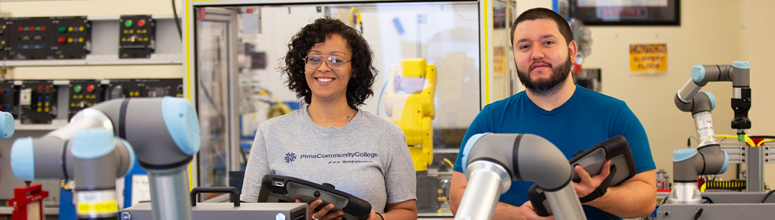 A male and female student working in PCC's Automated Industrial Technology lab. 