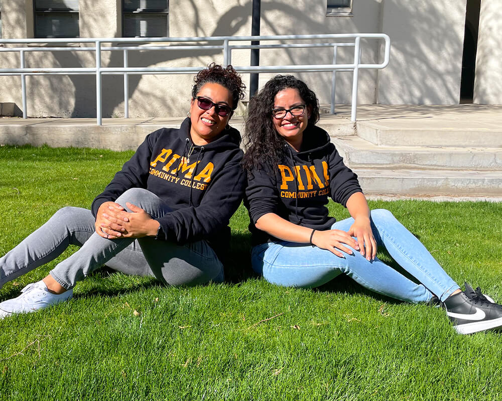 Student on the lawn at a pima campus.