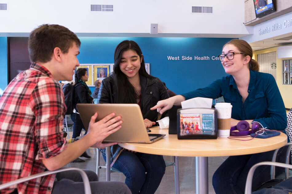Students sit at a round table in a campus cafe