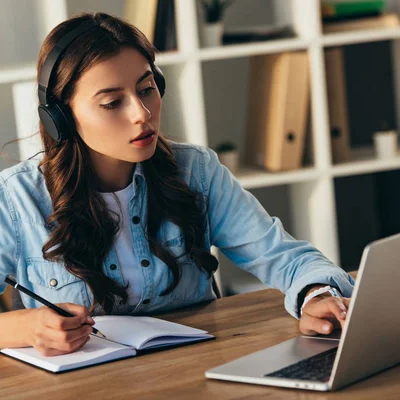 A student sits at a desk studying on a computer