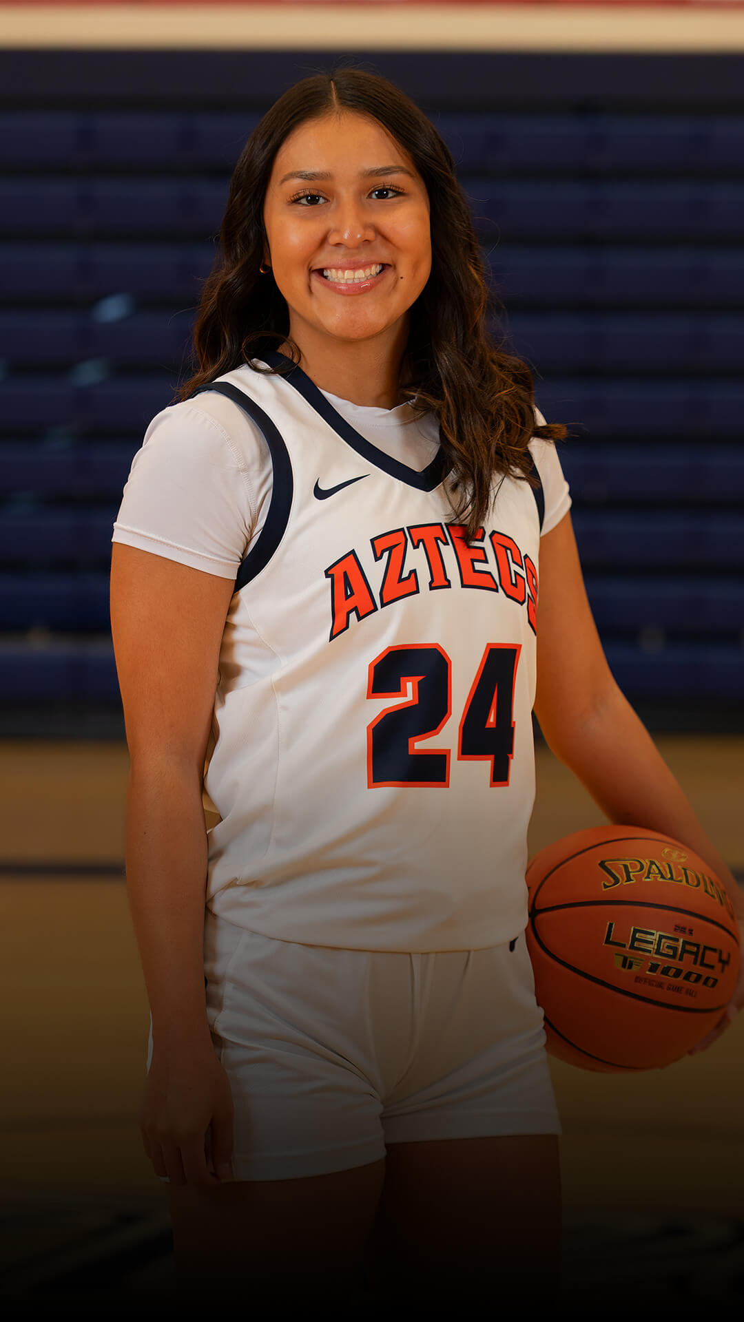 Melicia poses for with a basketball.