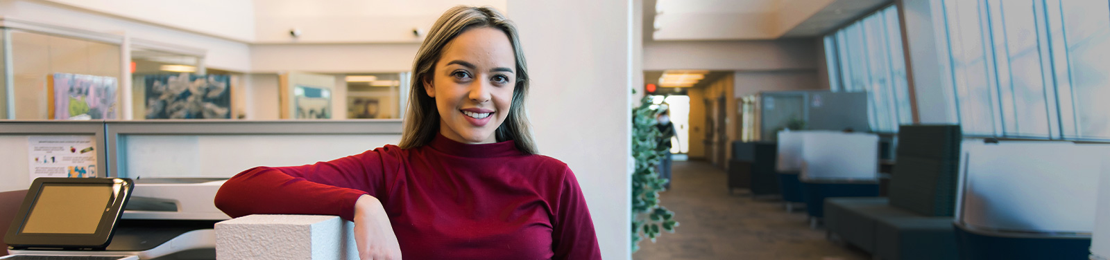 A student stands in a student lounge at a Pima Campus