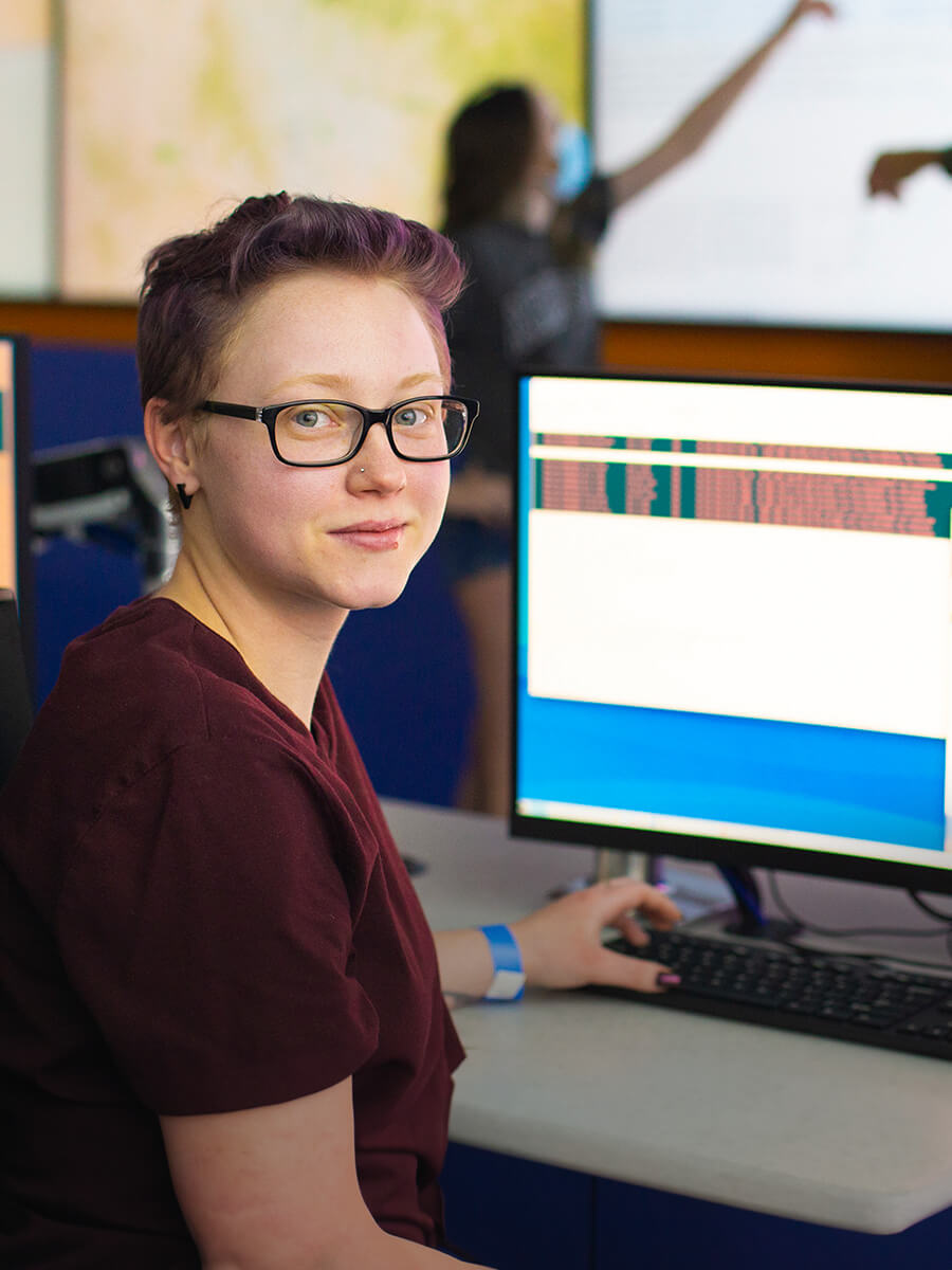 A student sits in Pima's Cybersecurity Center of Excellence