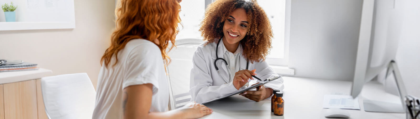 Medical personnel reviews paperwork with a patient