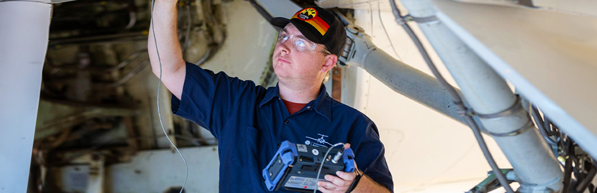 An Aviation student runs tests on an aircraft in the Pima's Aviation Center