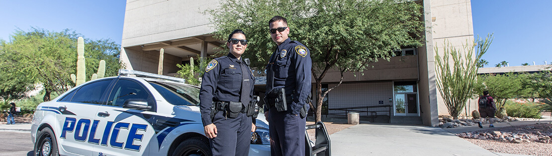 2 PCC police officers with police car