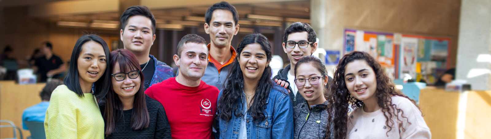 a group of students smiling in a Pima campus student lounge