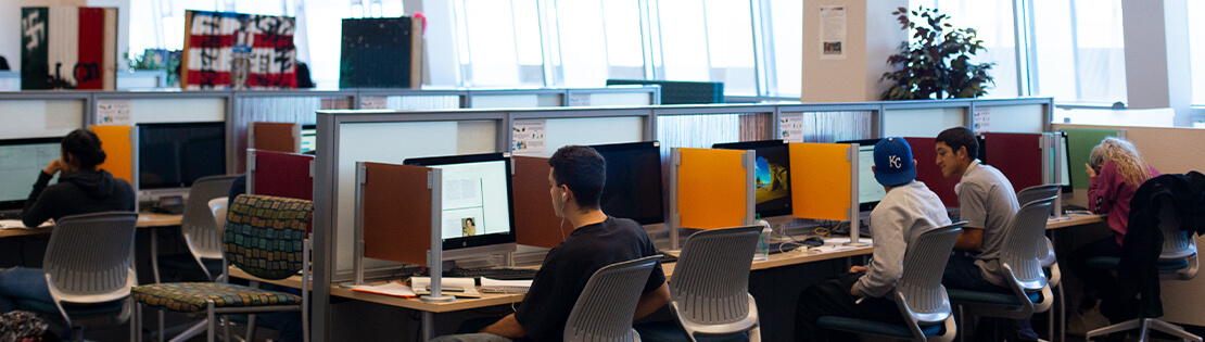 Students work in a Pima computer commons in a Pima library