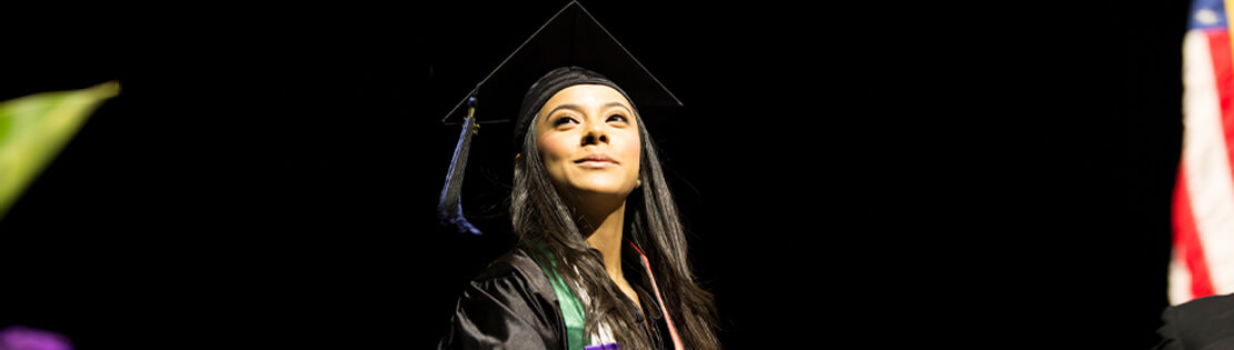 Student wearing cap and gown at PCC graduation