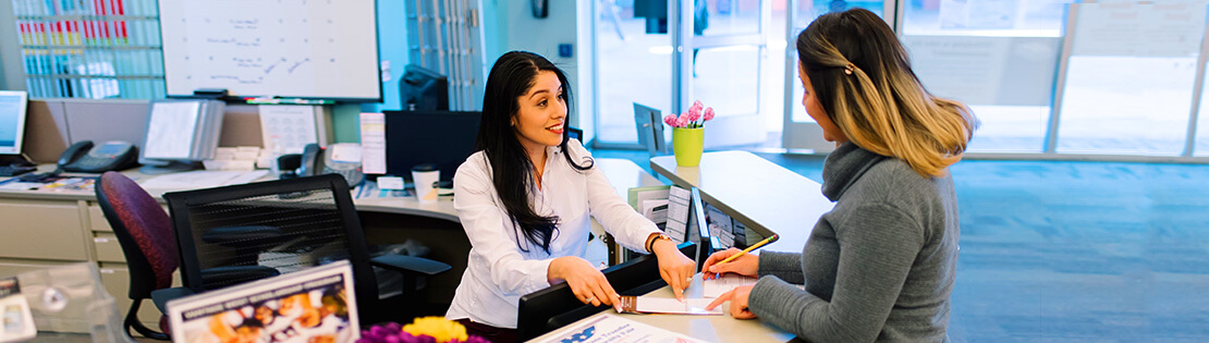 Student services employee assists a student